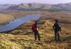 hikers looking over stream and hills